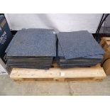 Pallet containing blue carpet tiles