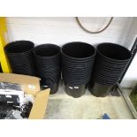 4 stacks of various size black plastic garden pots