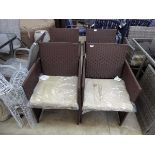 4 brown rattan garden armchairs each with beige coloured cushions