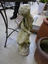 Weathered concrete garden statue in the form of a seated lady