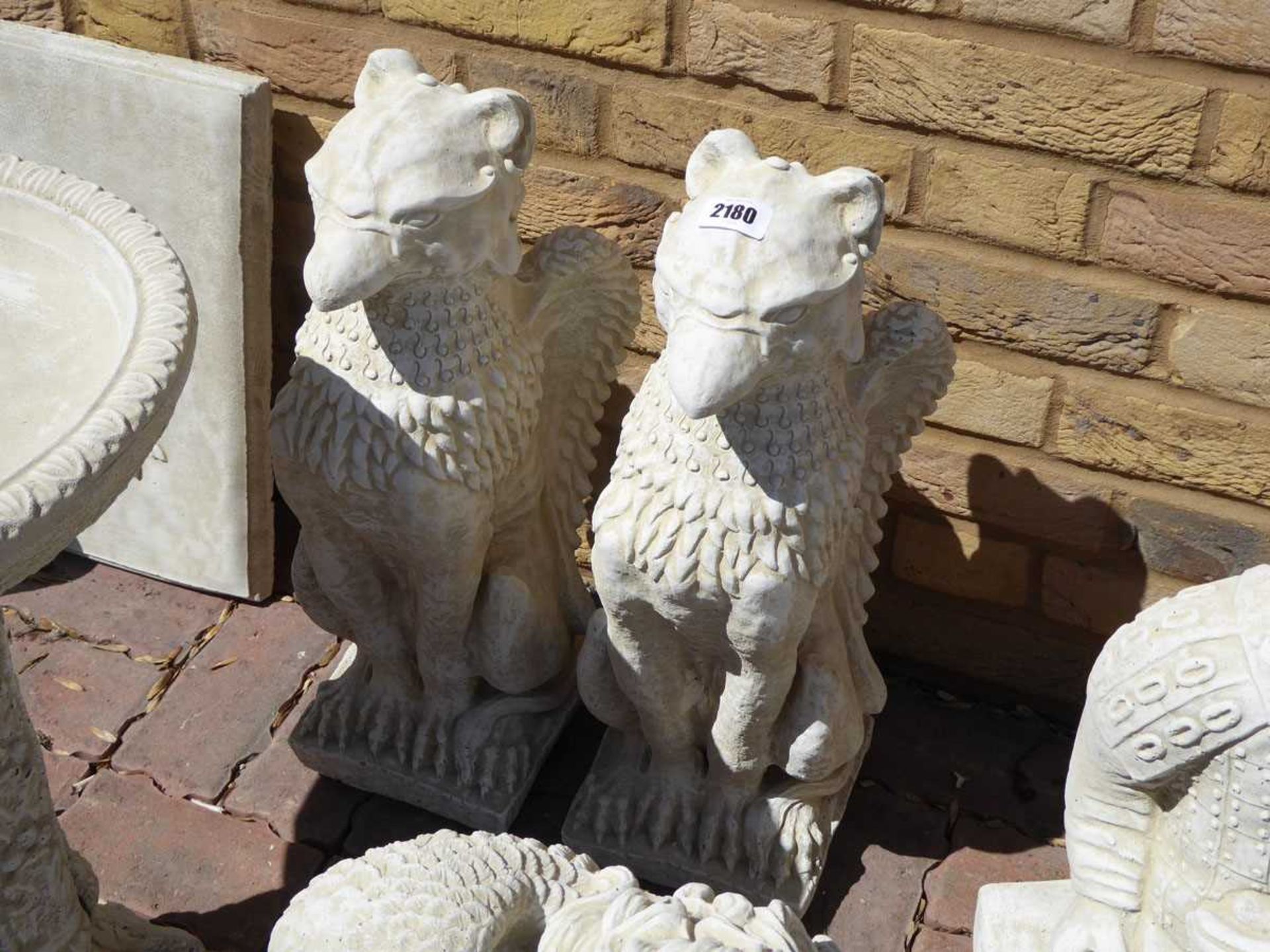 Pair of concrete sitting gryphons