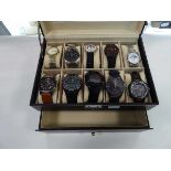 Box of 10 watches in display cabinet