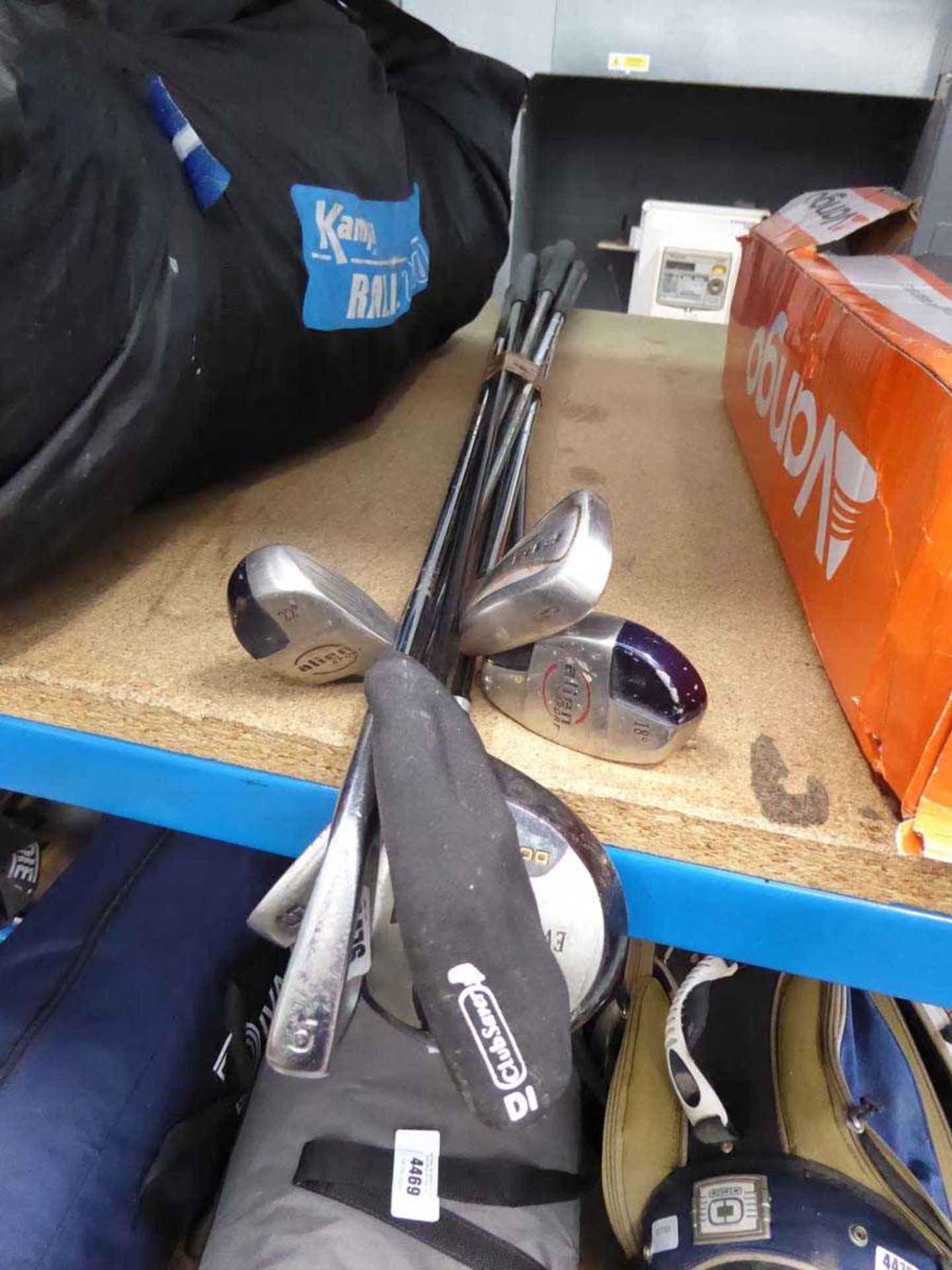 Quantity of assorted golf clubs