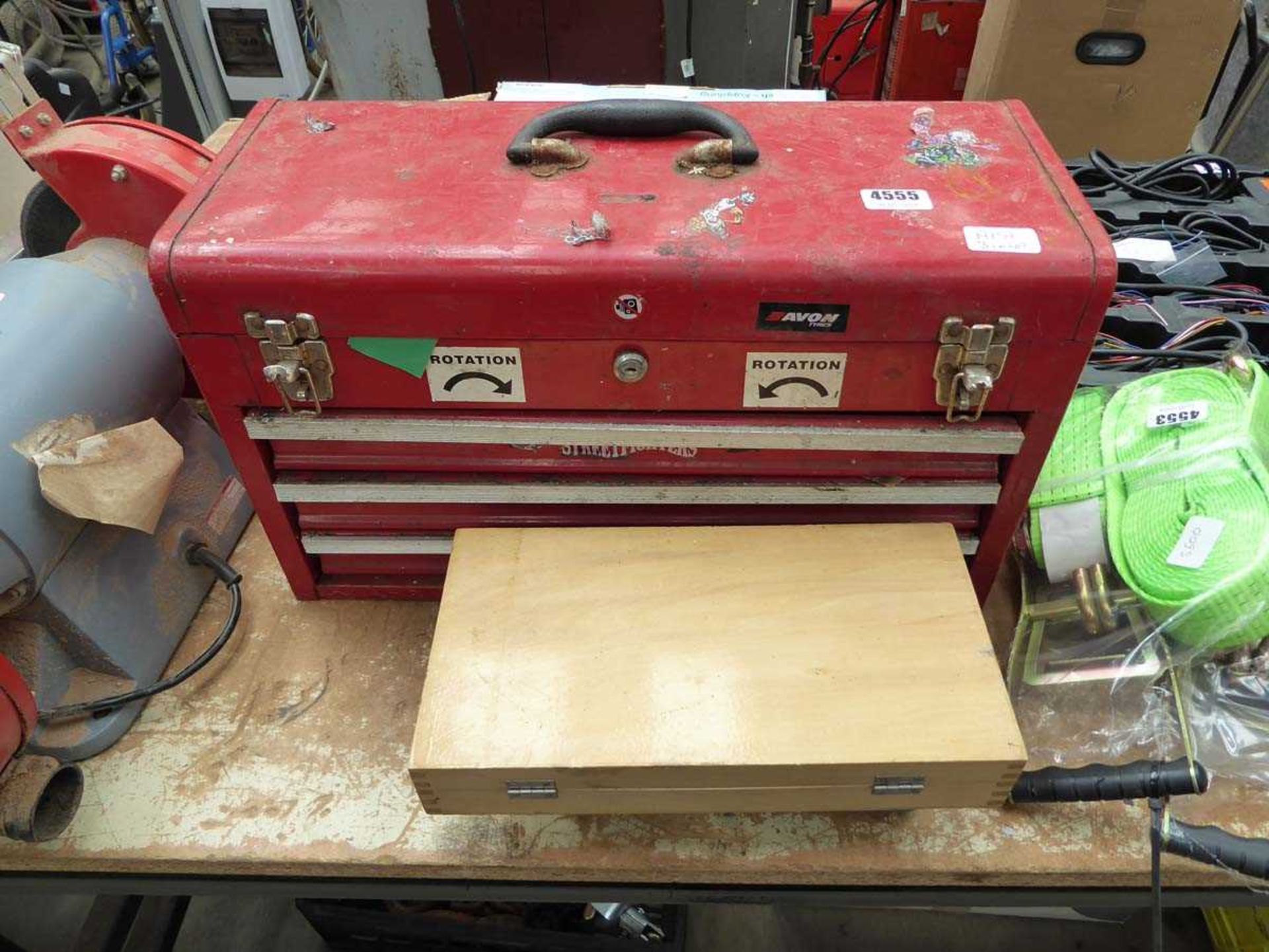 Red metal tool box containing assorted tools and two small boxes of fixings