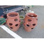 Two strawberry pots and a concrete pot