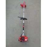 Red bent shaft petrol powered strimmer