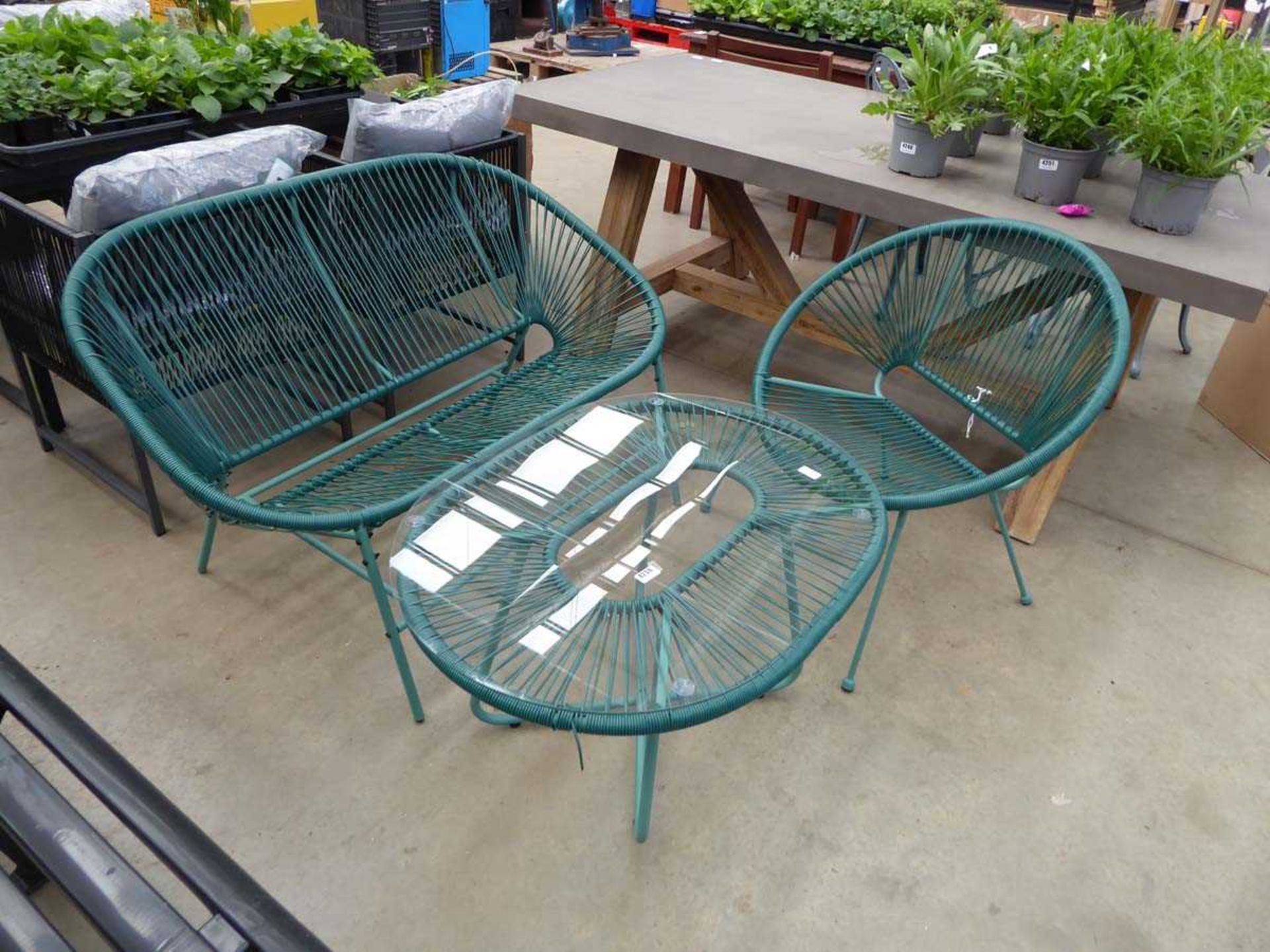 Three piece green string garden set to include a two seater bench, a chair and a glass topped coffee