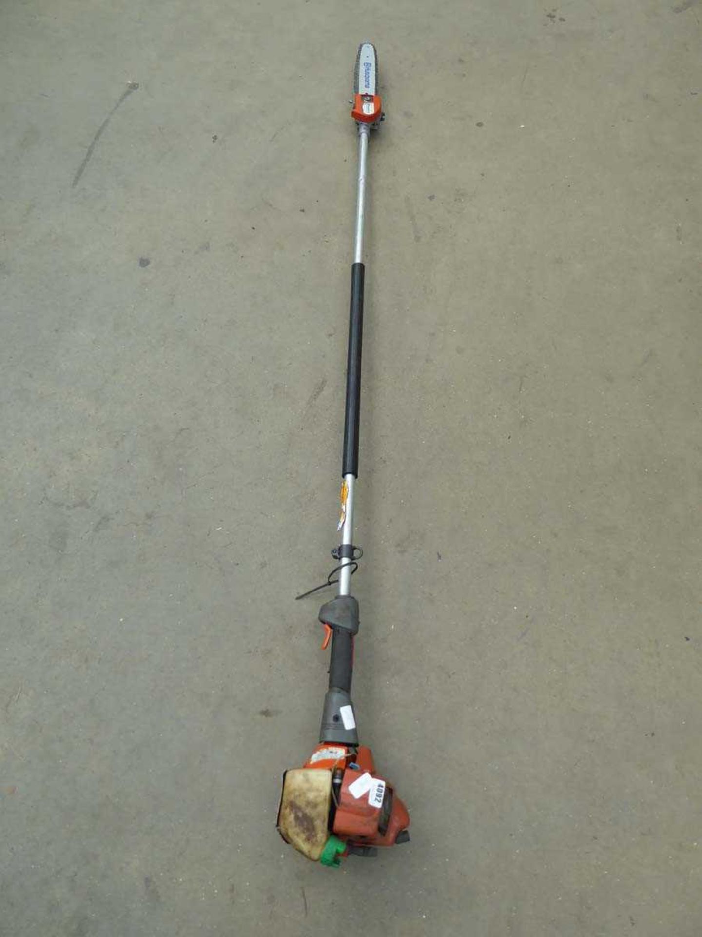 Orange Husqvarna petrol powered long reach chainsaw