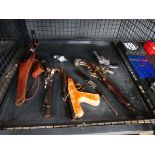 Cage containing an air pistol and various replica antique pistols