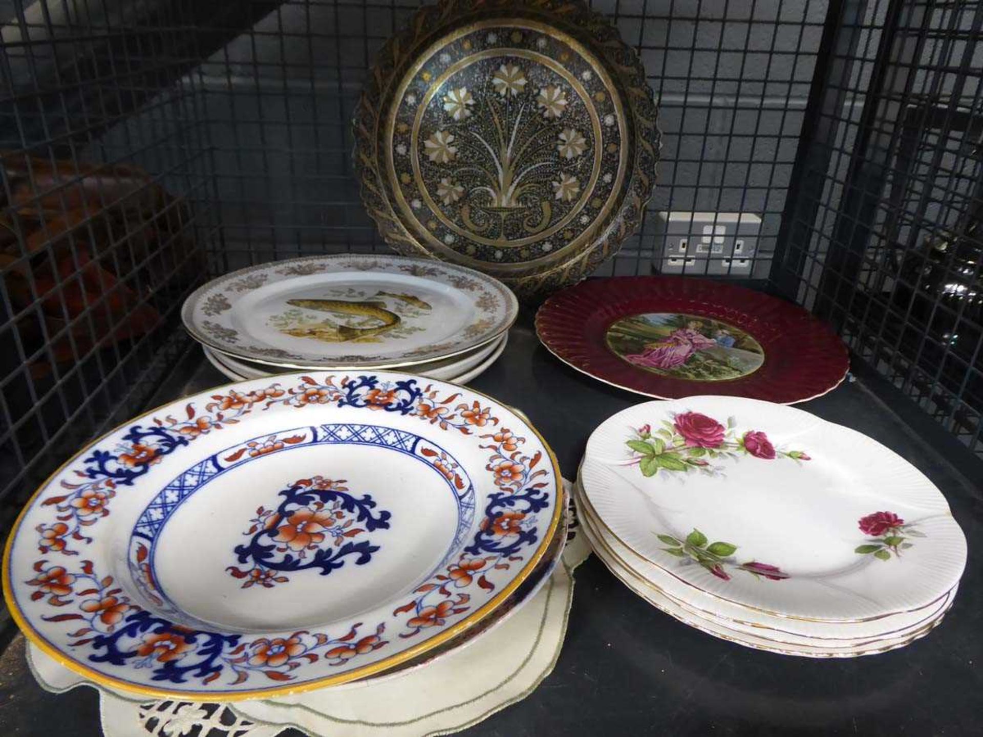 Cage containing assorted decorative plates