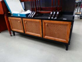 Low slung entertainment unit with three wicker panelled doors under