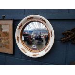 Circular convex mirror with cream and gilt painted frame