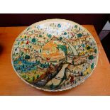 A Kashmiri(?) lacquered bowl, the central panel decorated with a figures at a temple, within a