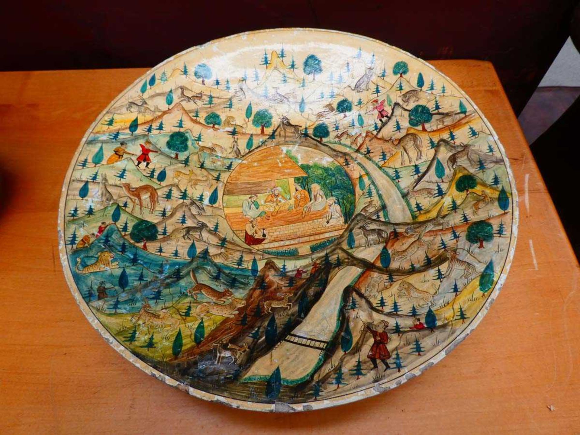 A Kashmiri(?) lacquered bowl, the central panel decorated with a figures at a temple, within a