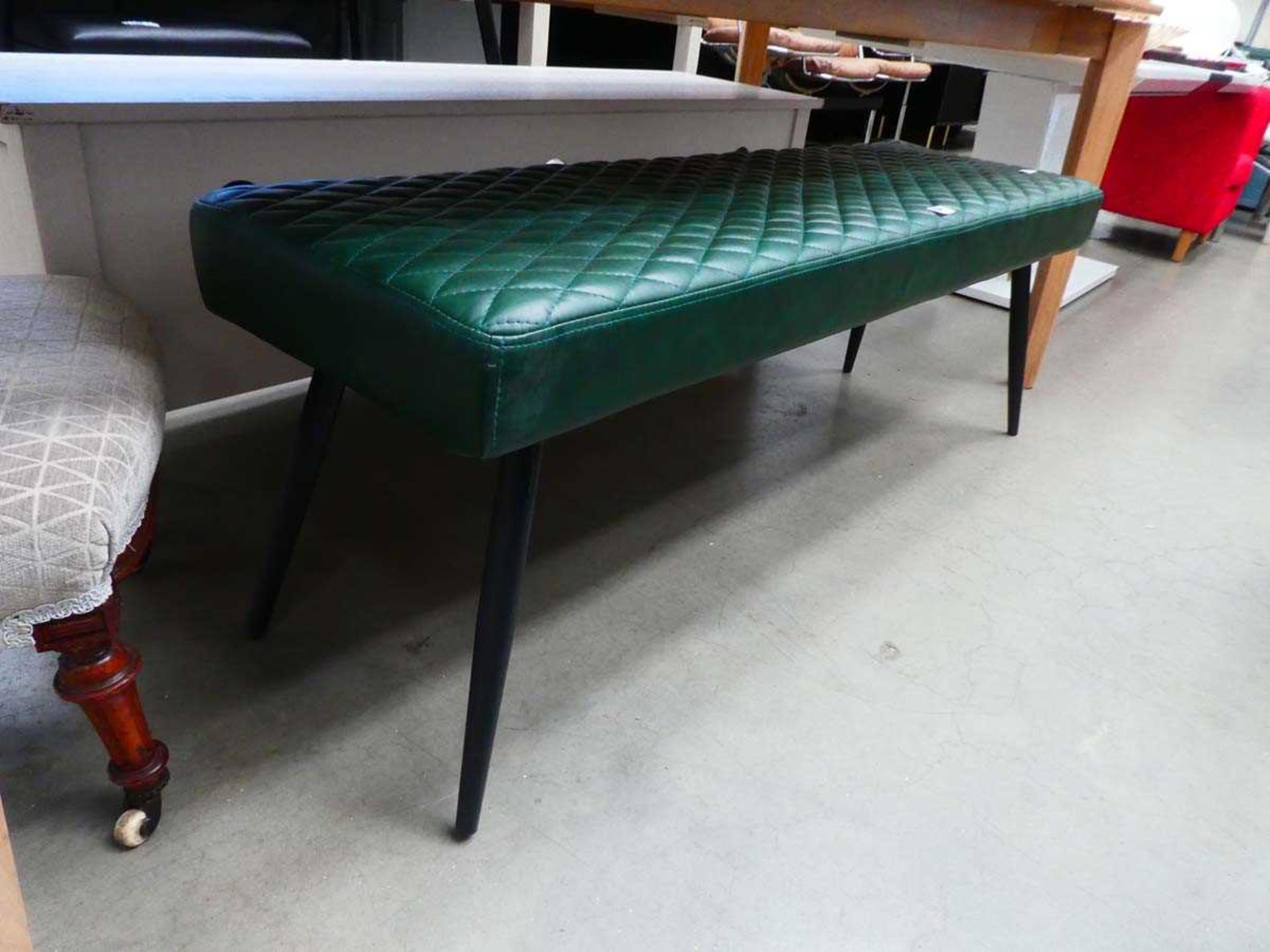 Green padded seat on spindle legs