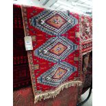 (15) Handmade woollen runner with red ground and repeated motifs