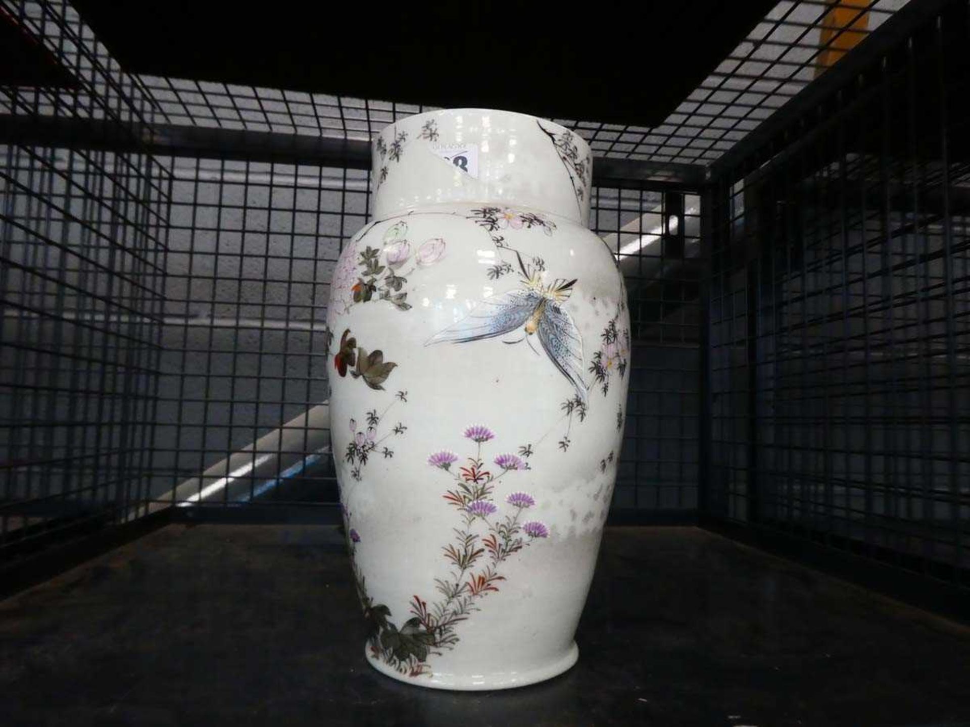 A Japanese vase of shouldered form, decorated in coloured enamels with a butterfly amongst flowers