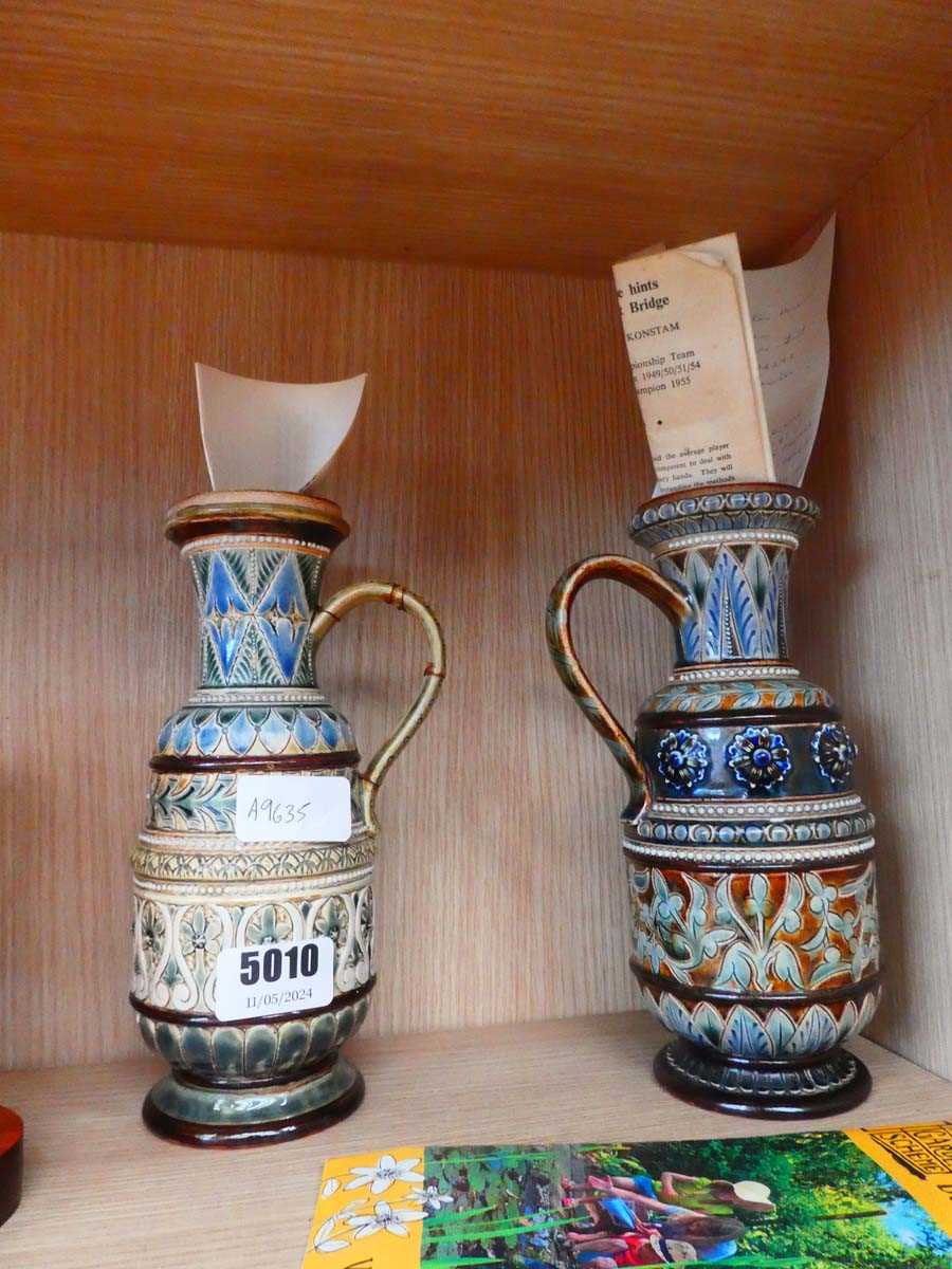 Two Doulton stoneware mugs One has extensive damage to handle but has been repaired.Height: 21cm