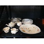 Cage containing pheasant patterned crockery
