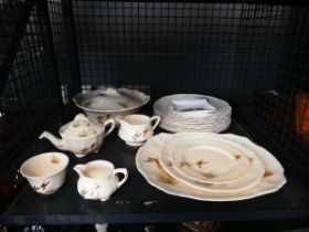 Cage containing pheasant patterned crockery