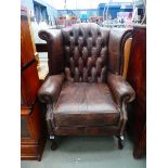 Brown button back wing back armchair