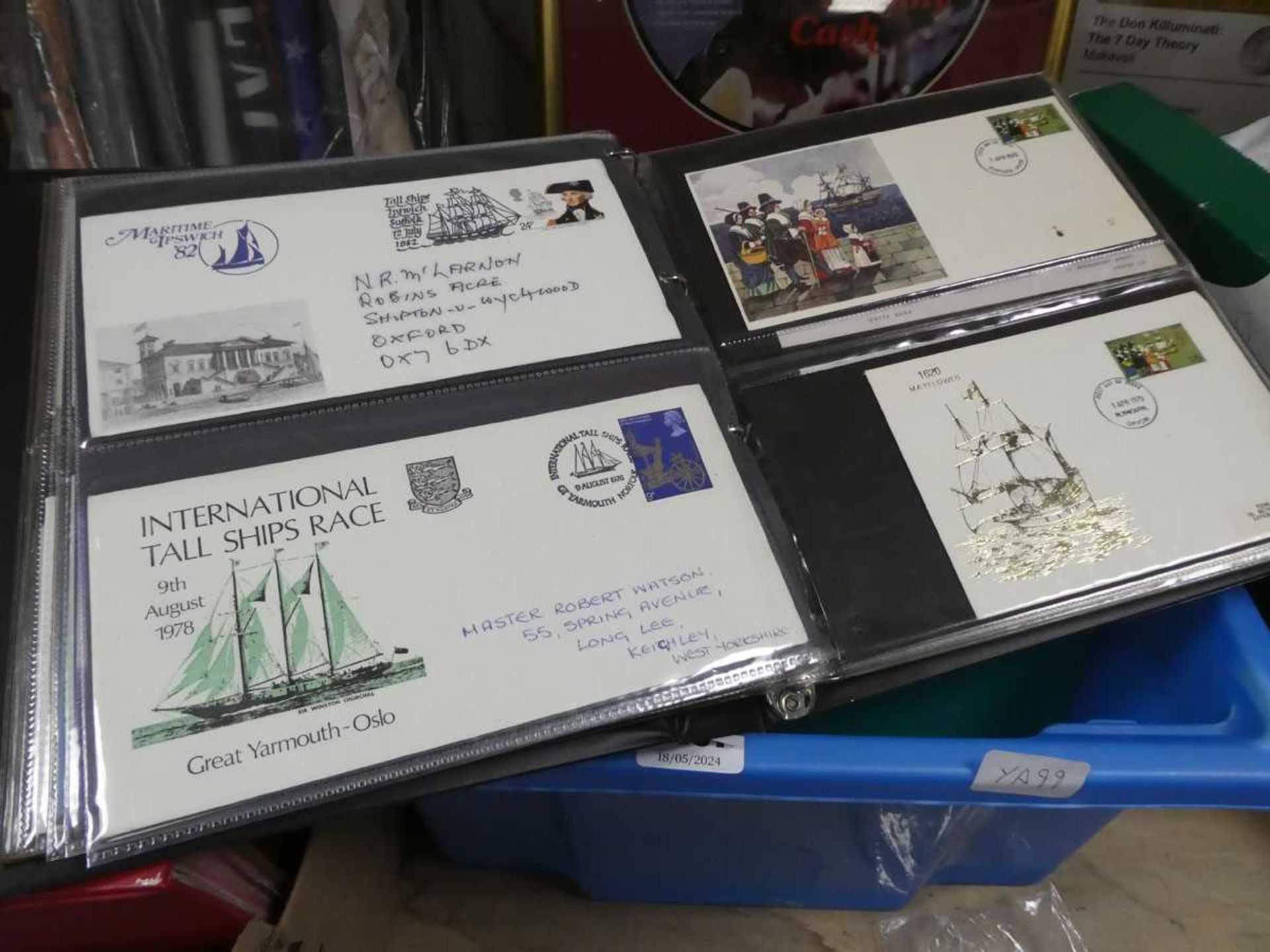 Box containing various first day covers in folders