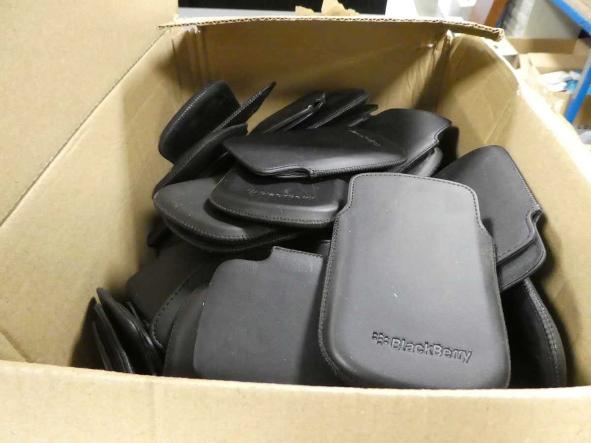 Box containing various Blackberry phone cases