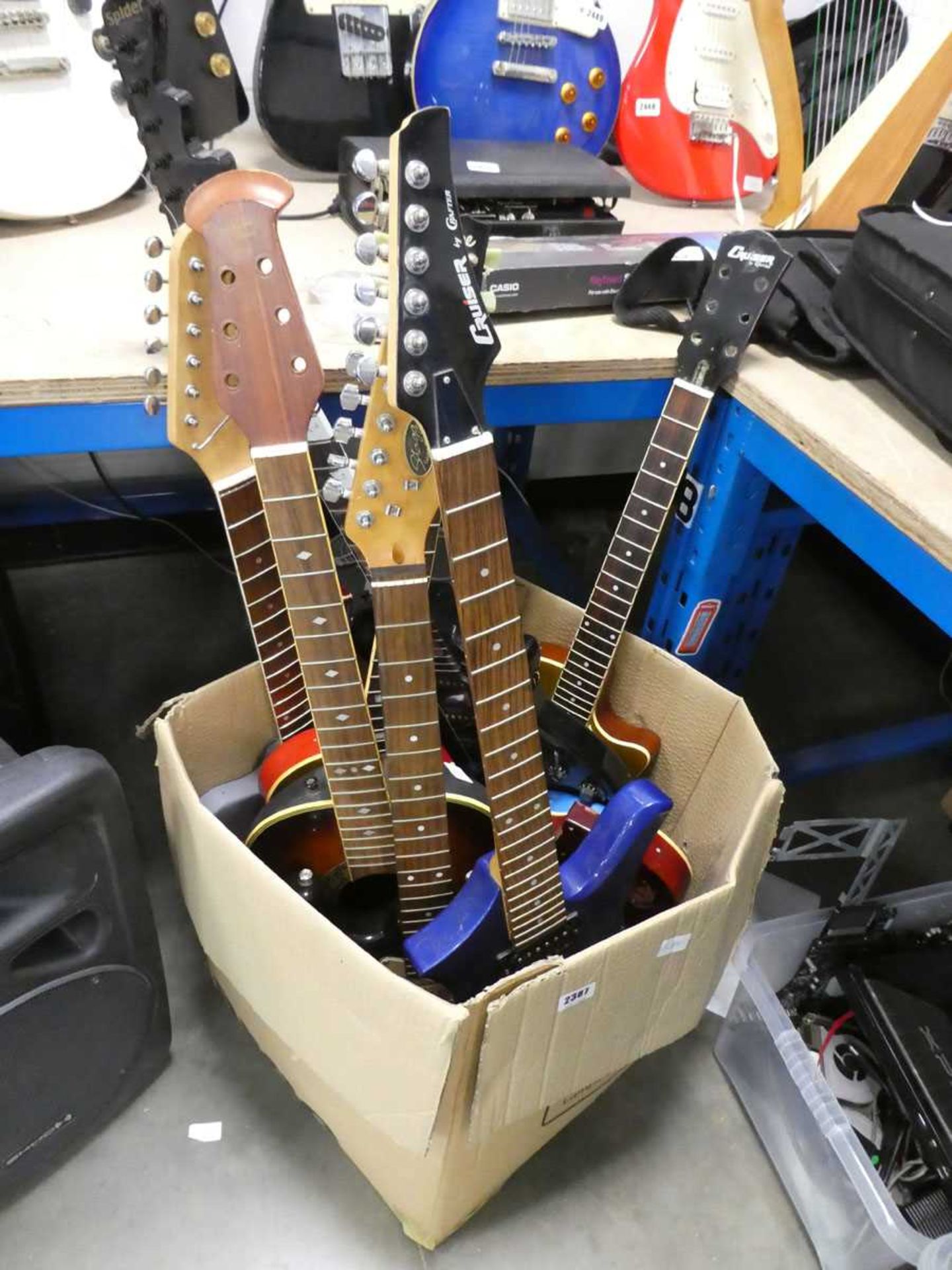 Box containing various guitar parts