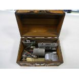 Box containing various items including hip flask, miniature binoculars, lighters etc.