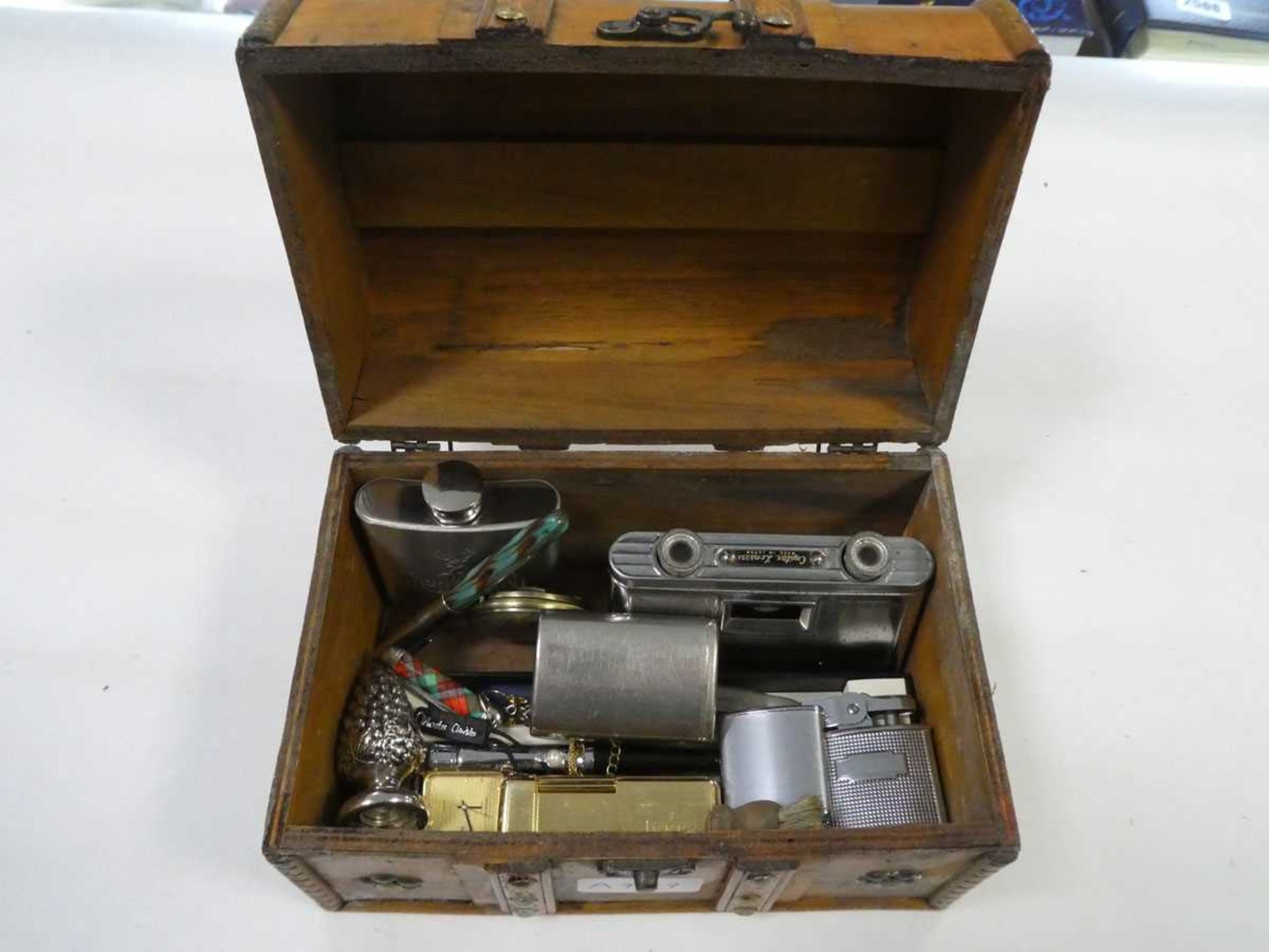 Box containing various items including hip flask, miniature binoculars, lighters etc.