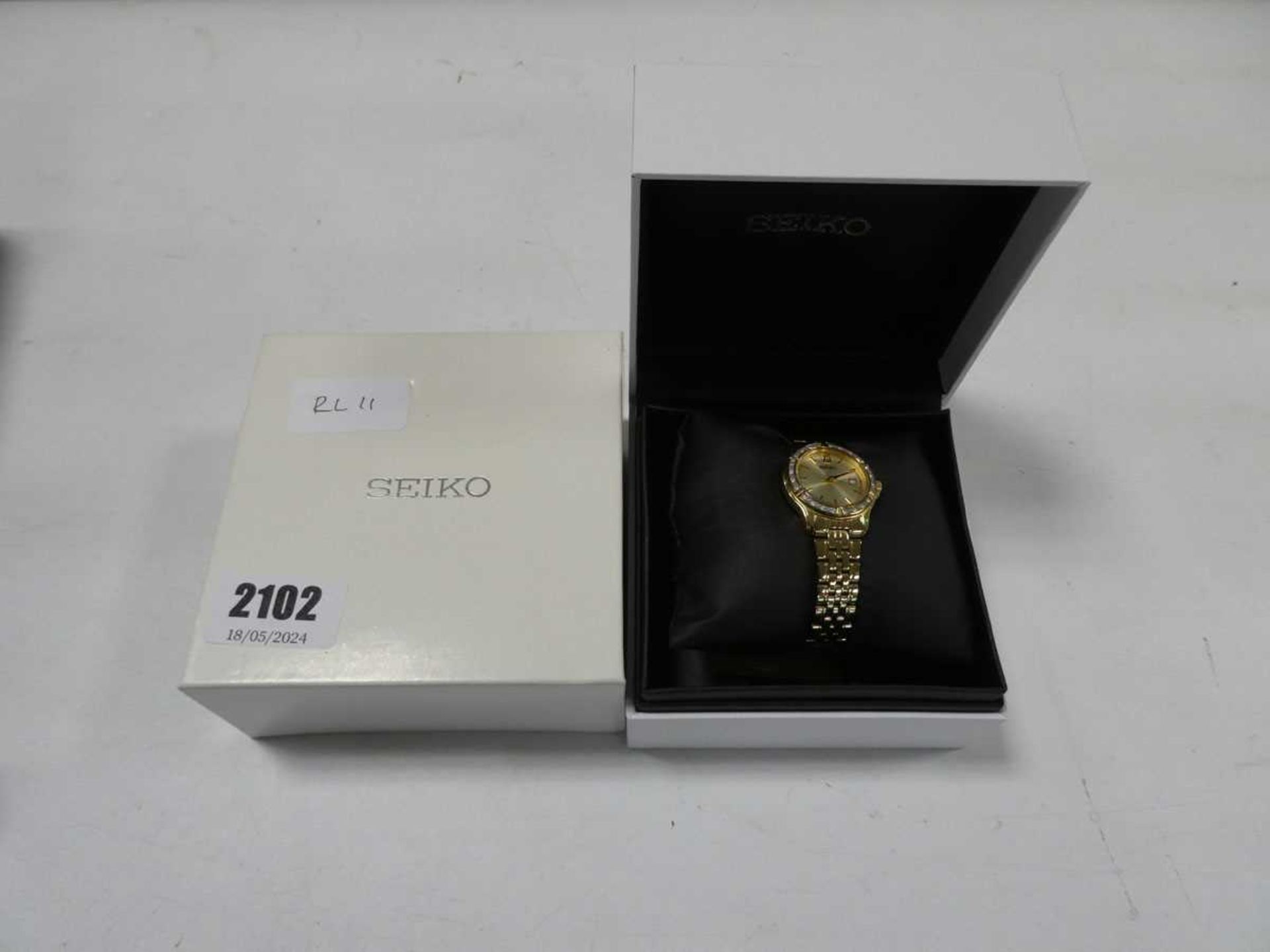 Seiko ladies wristwatch with gold face with bejewelled trim and gold coloured steel strap