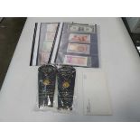 (2) 2 folders containing bank notes, with 2 Royal Mint coins, wedding souvenirs, and coins