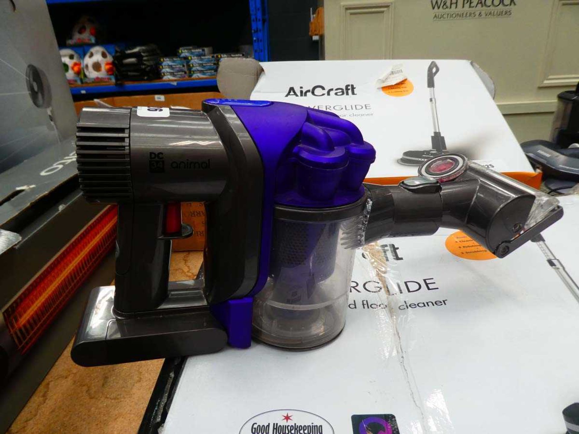 Handheld Dyson DC34 Animal with 1 attachment, no charger plus a pin pointer, and glassware