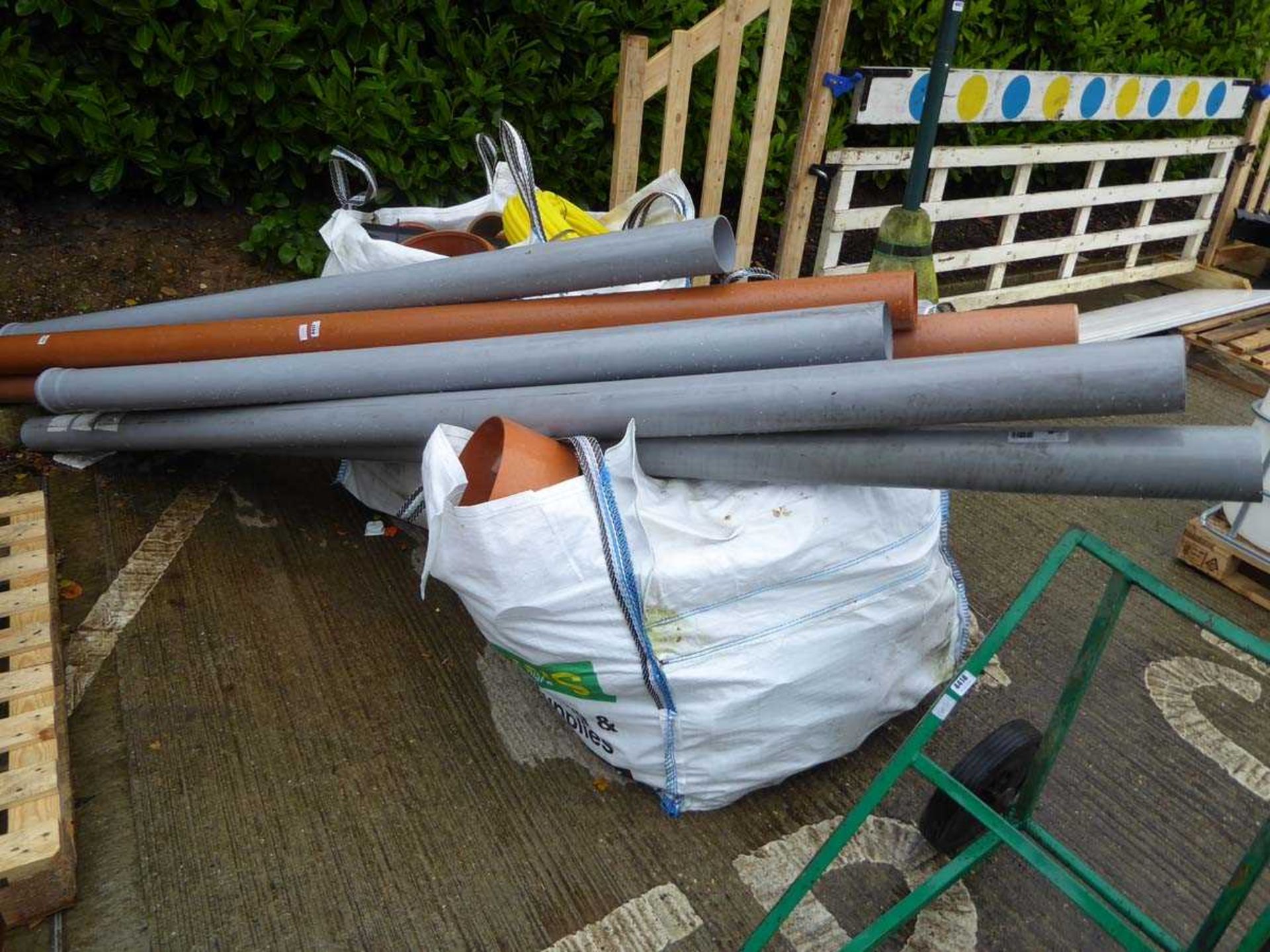 2 large bags containing drainage items plus large drainage pipes