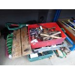 1/4 of an underbay containing tools, workbench, saws, strimmer etc.