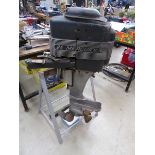 Mercury 25 petrol powered outboard motor on stand