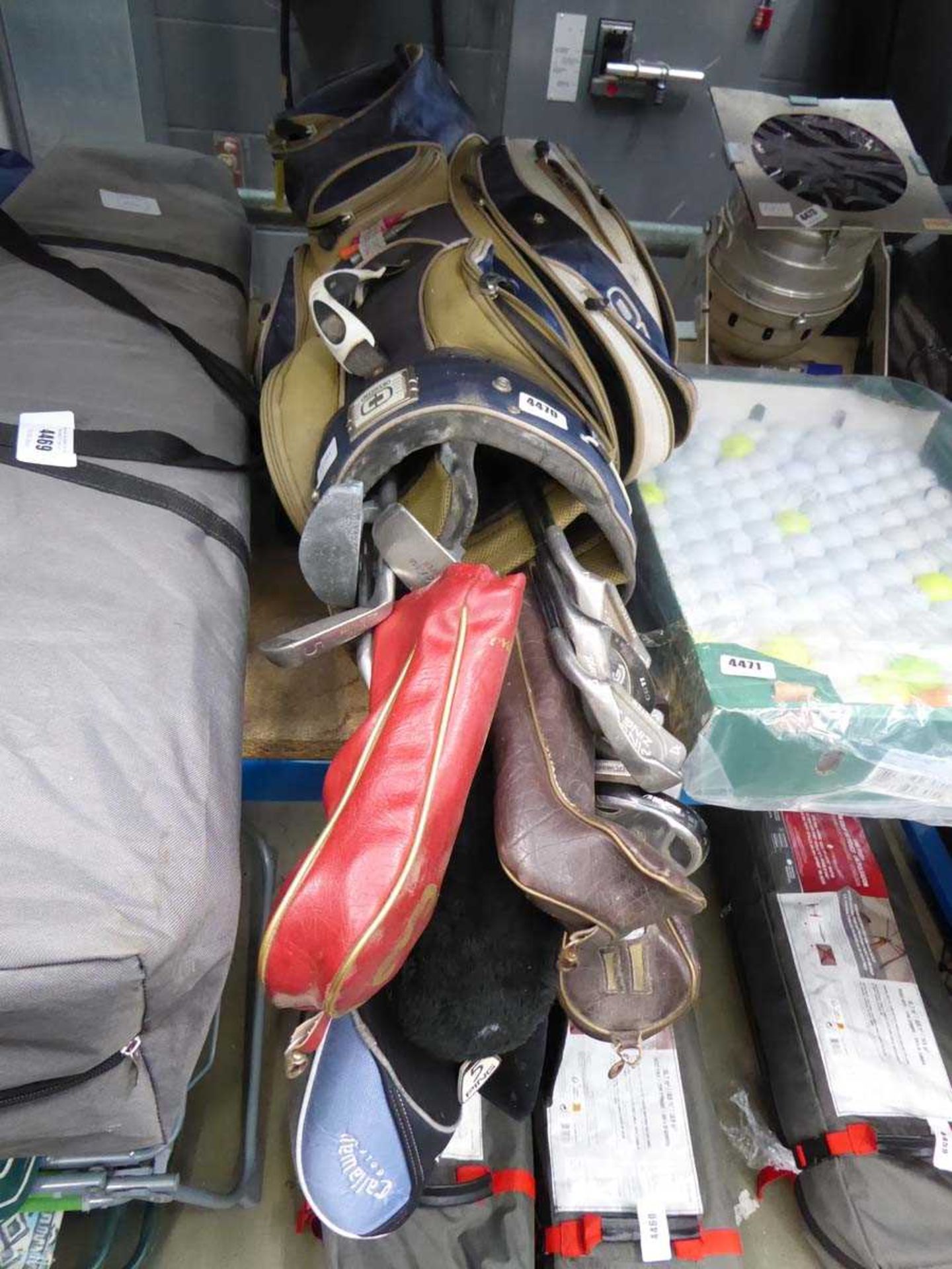 Beige and blue golf bag with assorted clubs