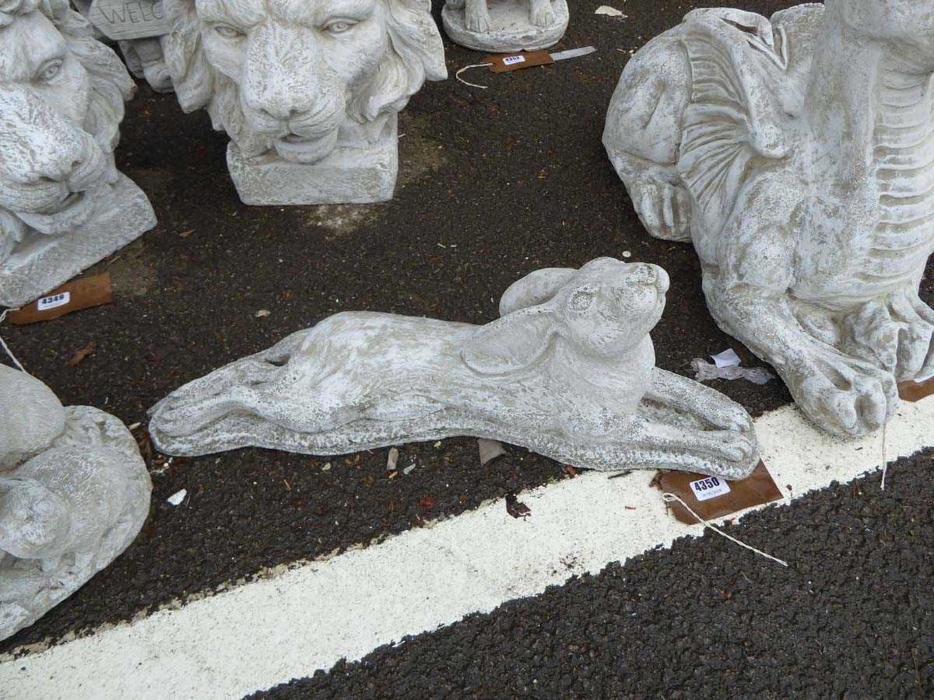 Concrete laying down hare and a family of rabbits