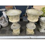 Pair of large ornate concrete planters on stands