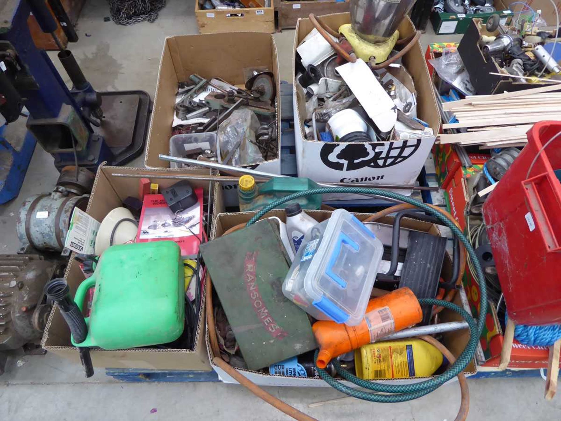 Pallet of assorted items including machine parts, oil, plumbing parts, heaters, etc