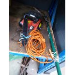 Red electric chainsaw, bar and chain unattached plus a pole saw
