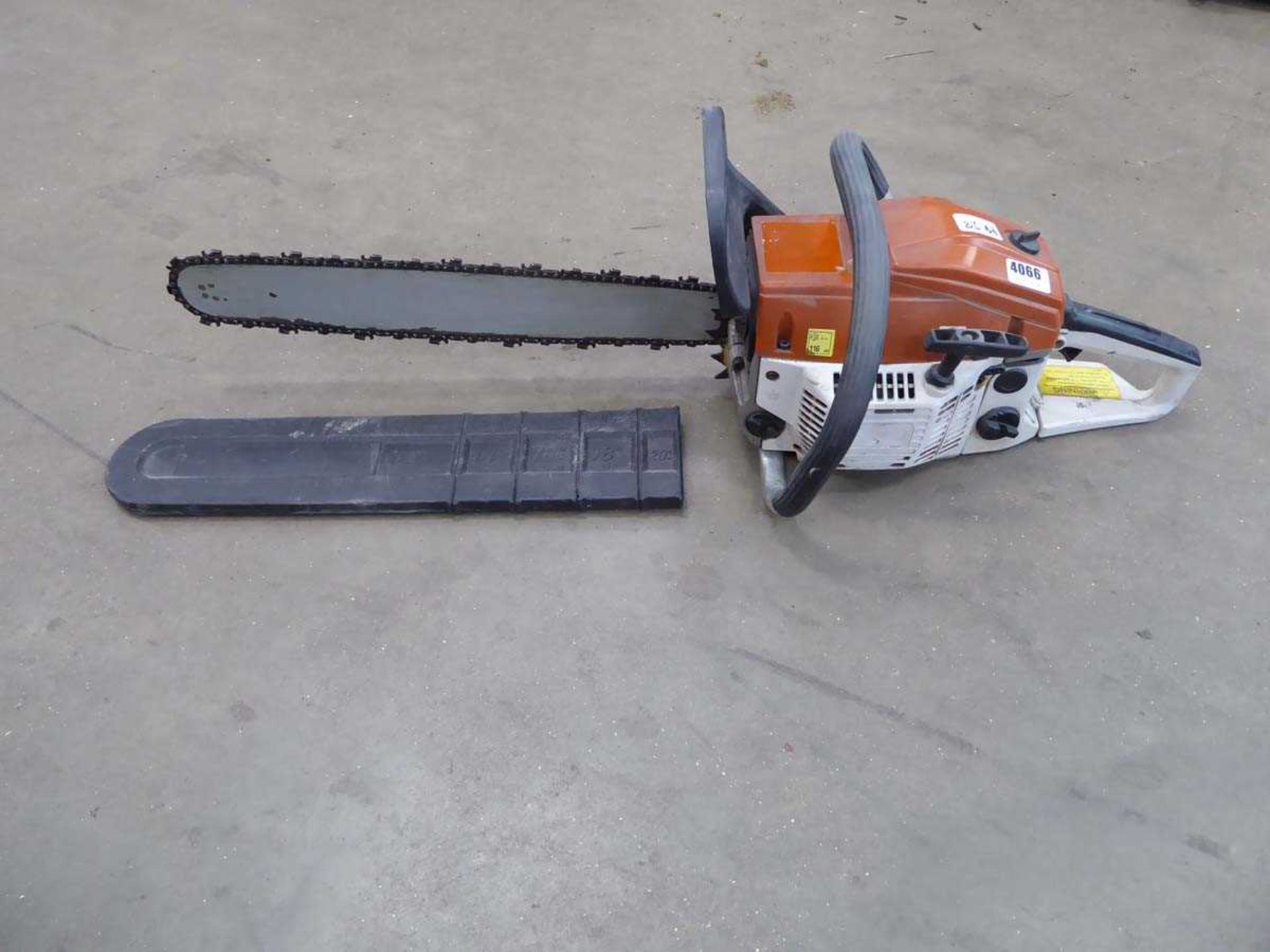 Orange and beige petrol powered chainsaw