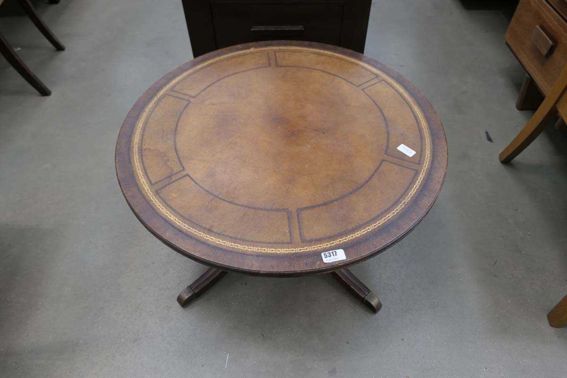 Circular reproduction coffee table with leather surface