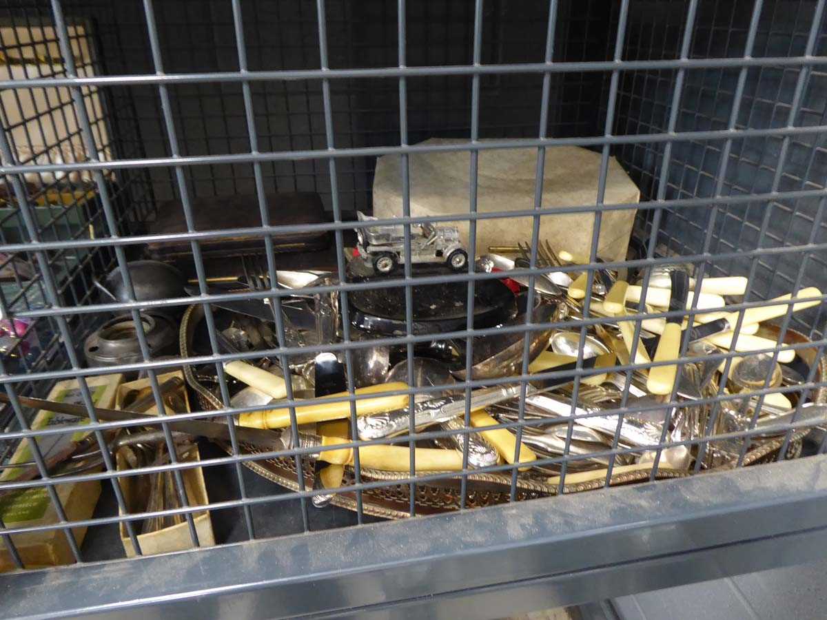 Cage of cutlery and a white metal ware tray
