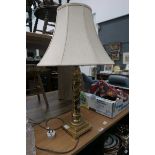 Table lamp on brass support with cream shade