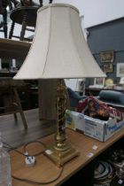 Table lamp on brass support with cream shade