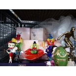Cage containing glass clown figurenes, footballing trophies, Betty Boop figures