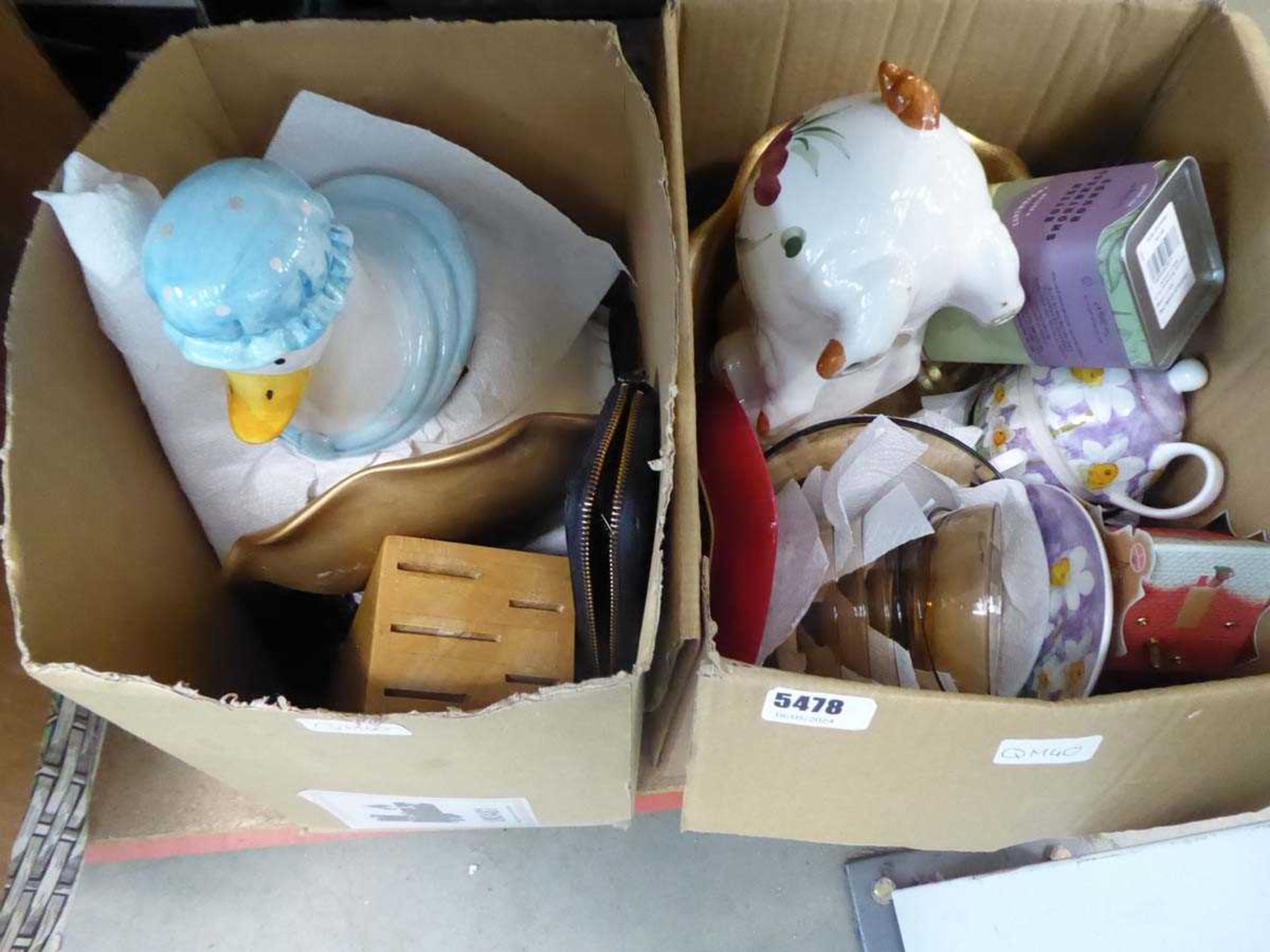 2 x boxes containing a piggy bank, tea pot, dishes, household goods and kitchen storage vessels