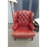 Red leather wing back armchair