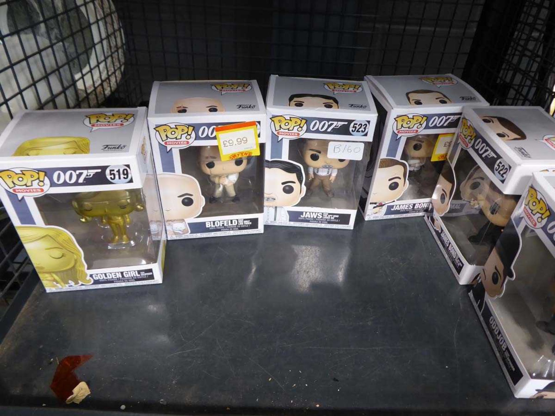 Cage containing Funko Pop! James Bond head figures